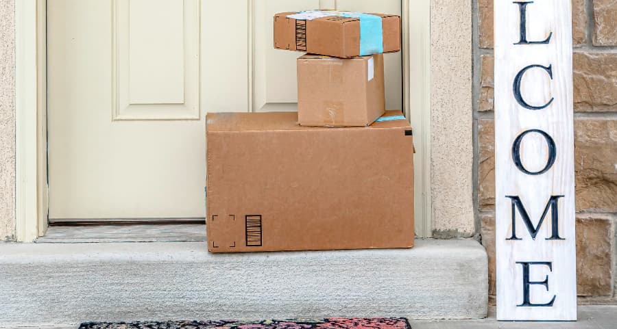 Deliveries on the front porch of a house with a welcome sign in San Antonio